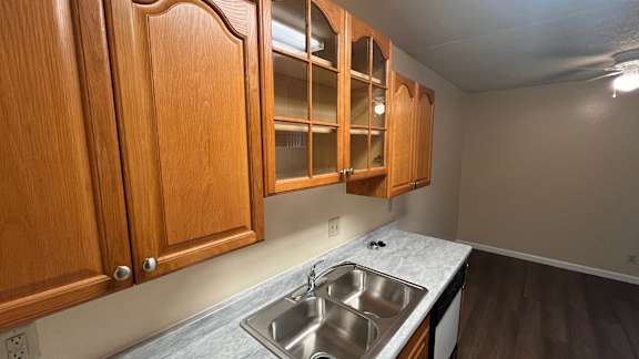 Kitchen with wooden cabinets and a granite countertop at Vacaville Park Apartments, Vacaville