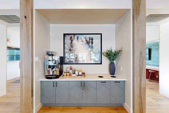 A kitchen with a large painting hanging above the counter at The Villas at Anacapa Canyon, Camarillo