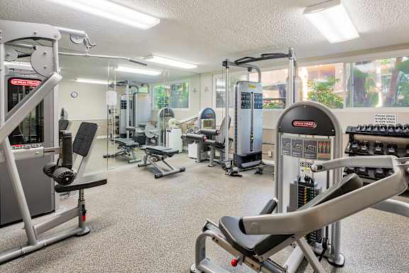 A gym with a variety of equipment including a leg press machine at Casa Granada, California, 90049
