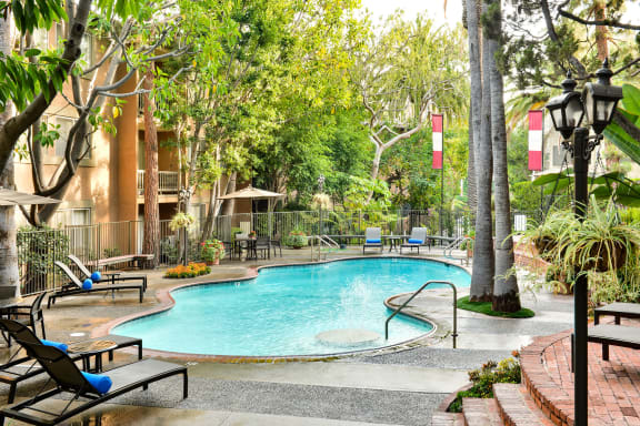 a swimming pool at a hotel with trees and a resort style pool at Casa Granada, California, 90049