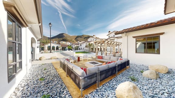 a living area with a couch and a table and a pool at The Villas at Anacapa Canyon, Camarillo, 93012