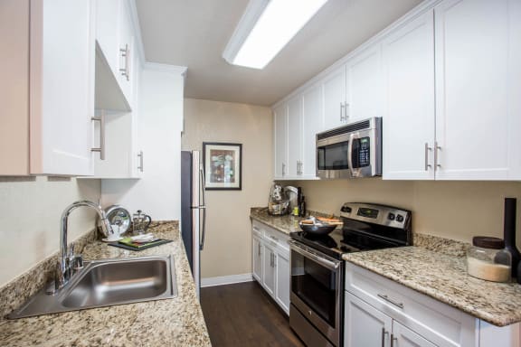 a kitchen with stainless steel appliances and granite counter tops  at Valley Plaza Villages, Pleasanton, California