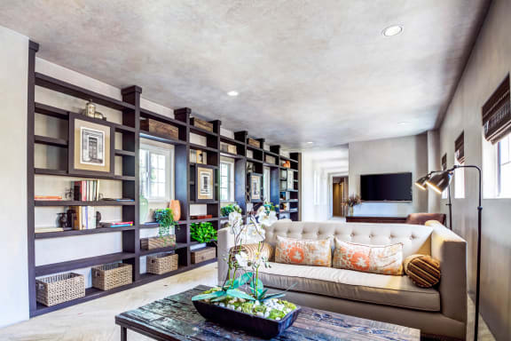 a living room with a couch and a bookshelf  at L'Estancia, Studio City, CA