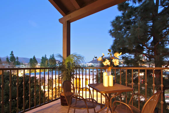a balcony with a table and chairs and a view of the beach  at L&#x27;Estancia, Studio City, California