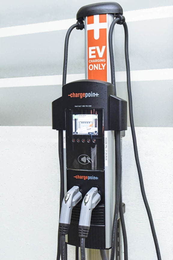 a charger for an electric vehicle plugged into a charging station at Marina Harbor, Marina del Rey