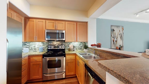 a kitchen with granite counter tops and stainless steel appliances  at Marina Harbor, Marina del Rey, California