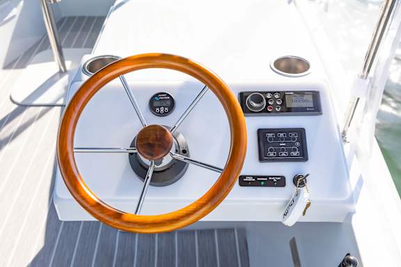 The steering wheel and control panel of a Duffy Boat