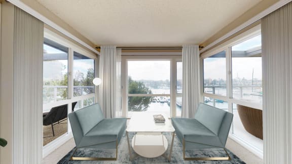 a living room with two blue chairs and a table and a view of the water  at Marina Harbor, Marina del Rey