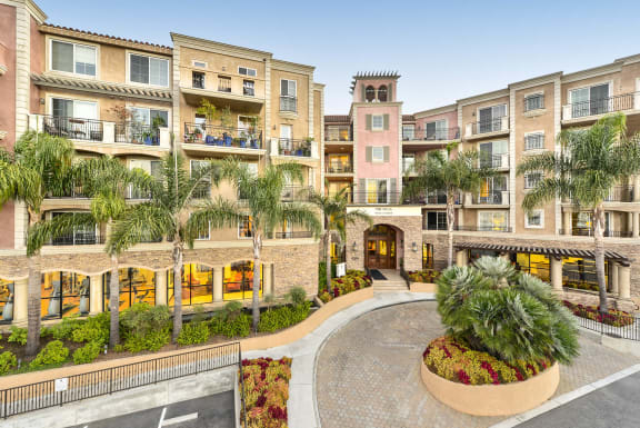 a courtyard with palm trees in front of an apartment building  at Marina Harbor, Marina del Rey, CA