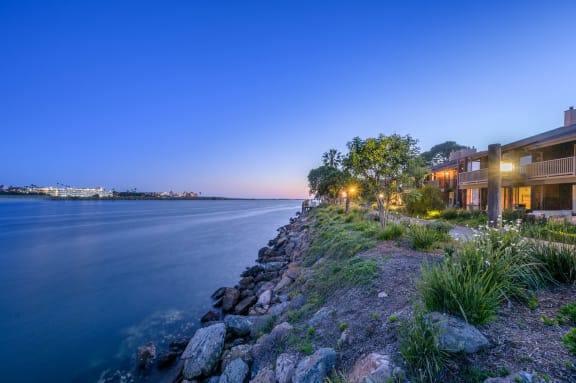 a home on the water overlooking the water at night at Mariners Village, Marina del Rey, California