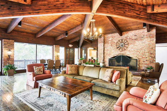 a living room with furniture and a brick fireplace at The Meadows Apartments, Culver City , CA 90230