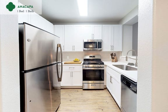 a kitchen with stainless steel appliances and white cabinets at Mission Hills, California, 93012