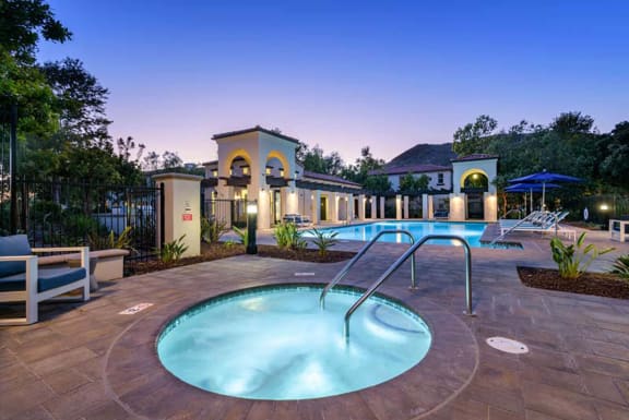 a swimming pool with chairs and a fountain in front of a house at Mission Hills, Camarillo, CA