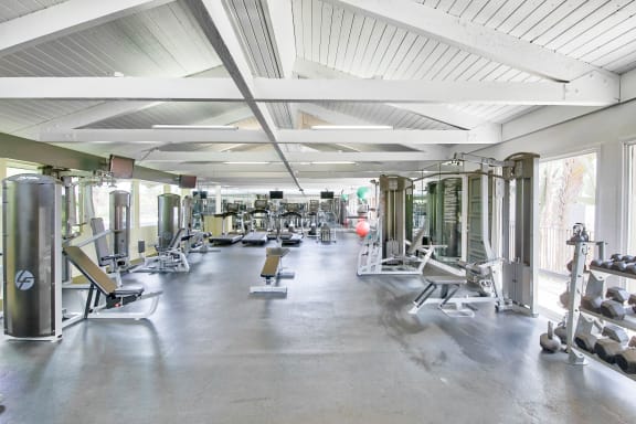 a gym full of weights and cardio equipment at Mediterranean Village Costa Mesa, Costa Mesa, CA, 92626