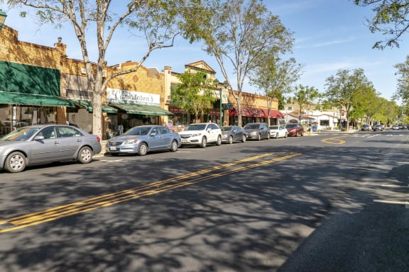 a row of cars parked on the side of a street  at Pleasanton Place, Pleasanton, CA, 94566