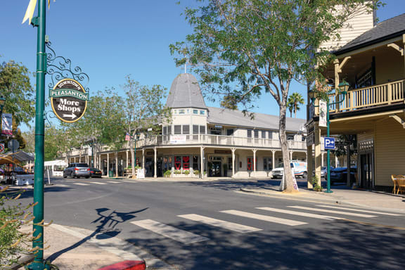 a city street with a building with a cone on the corner  at Pleasanton Place, California