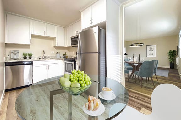 a kitchen with stainless steel appliances and a glass table at Pleasanton Glen Apartments, Pleasanton