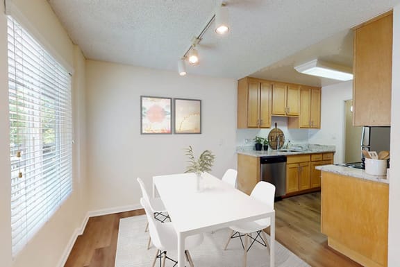 a dining room and kitchen with a white table and chairs at Pleasanton Glen Apartments, Pleasanton, 94566