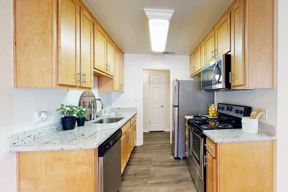 a kitchen with wooden cabinets and stainless steel appliances at Pleasanton Heights, Pleasanton, CA