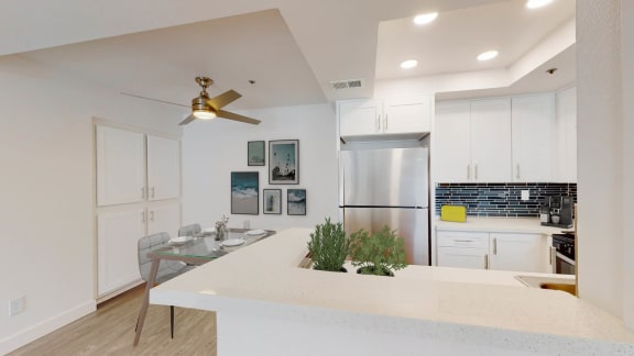 a kitchen with a white counter top and a stainless steel refrigerator at Sendero Huntington Beach, Huntington Beach, CA