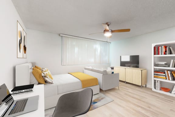 a living room with a bed and a desk with a laptop at Casa Granada, California