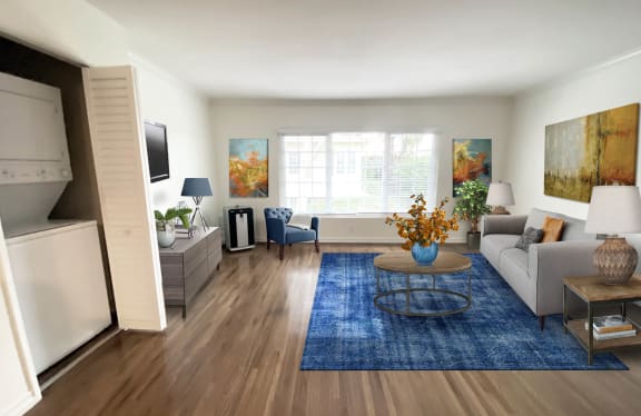 a living room with a blue rug and a white couch  at Sunset Barrington Gardens, Los Angeles, California