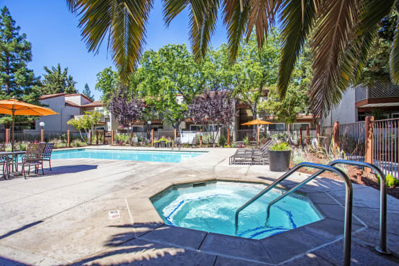 our apartments have a swimming pool and a patio with umbrellas at Valley Plaza Villages, Pleasanton, 94566
