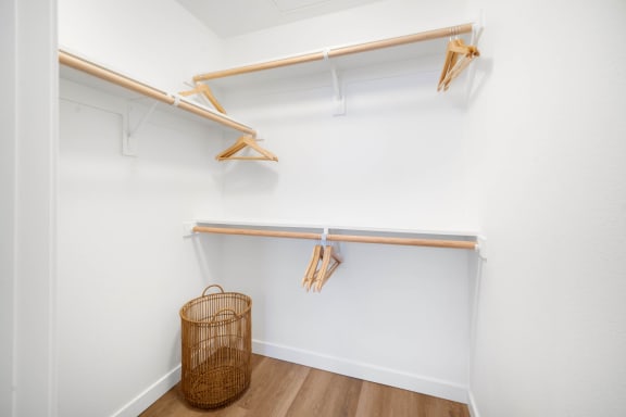 a walk in closet with shelves and a basket on the floor at The Villas at Anacapa Canyon, Camarillo
