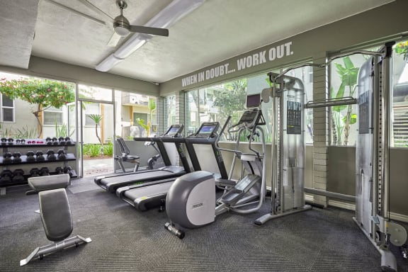the gym is equipped with state of the art equipment including cardio machines and weights at West Park Village, Los Angeles, CA