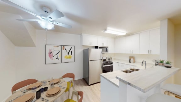 a dining room and kitchen with a table and a ceiling fan at West Park Village, Los Angeles, 90025