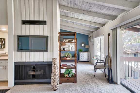 A living room with a fireplace and a chair.