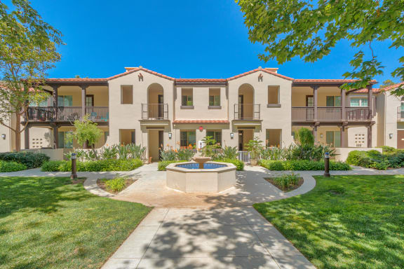 a courtyard with a fountain in front of an apartment building  at Mission Hills, Camarillo, 93012