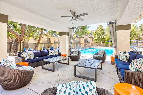 A patio with a pool and furniture at Mountain Vista, Victorville, CA