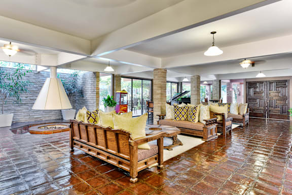 A living room with a couch and a table at Mediterranean Village West Hollywood, California