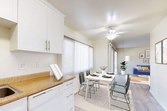 A kitchen with a table and chairs in the middle of the room.