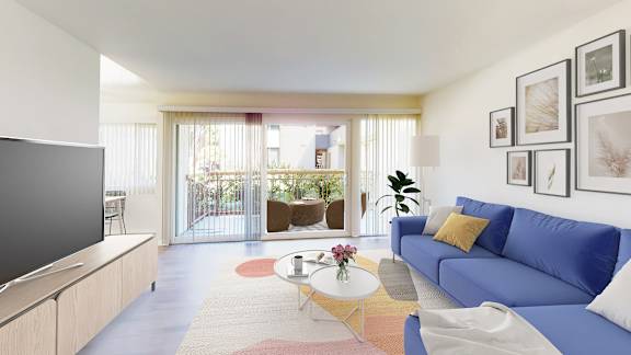 A living room with a blue couch and a television.