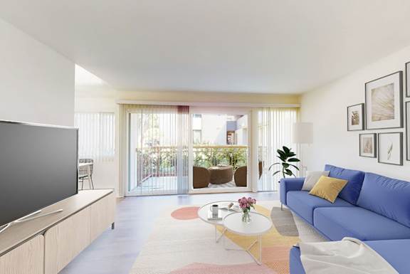 A living room with a blue couch and a television.