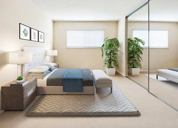 A bedroom with a bed, nightstand, and potted plants at Pleasanton Place, Pleasanton, CA, 94566