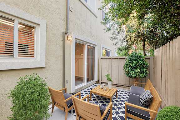 A patio with a table and chairs.