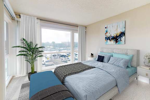 A bedroom with a large bed and a view of a pool and trees outside the window.