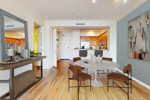 A dining room with a white table and chairs.