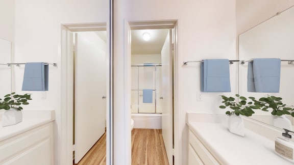 a bathroom with a mirror and a sink and a shower at Village Pointe Apartments, Northridge, CA, 91325