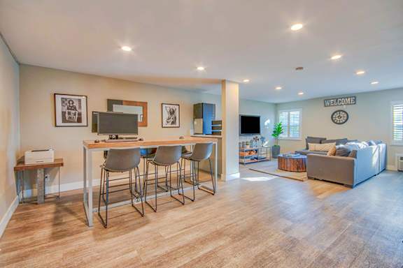 A living room with a couch, a television, and a bar area at Villa Vicente, Los Angeles, CA, 90019