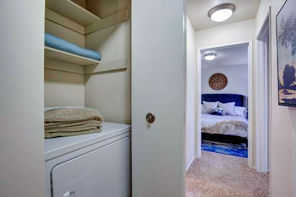 A small laundry room with a washer and dryer.