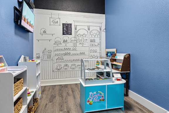 A blue and white café with a menu on the wall.