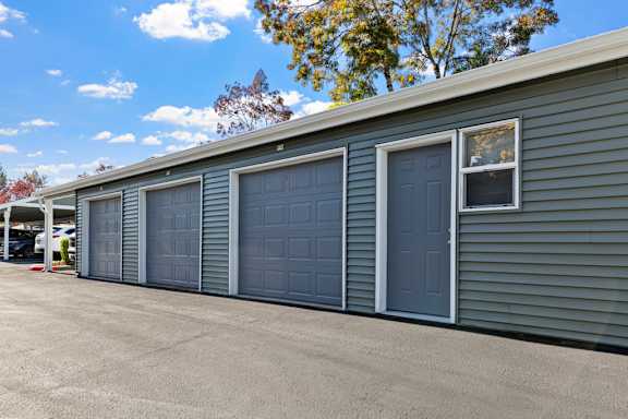 A long building with four garage doors.