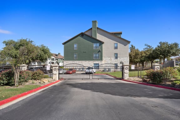 the view of a house with a gate a at The Fairways at Star Ranch, Huttond a driveway