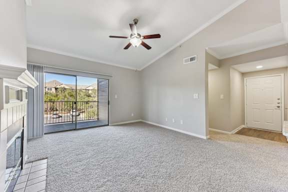 A spacious living room with a ceiling fan and sliding glass doors. at Sonterra Apartment Homes, Austin