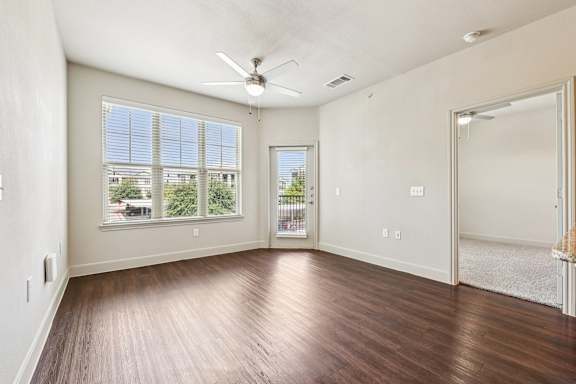 A room with a ceiling fan and a view of the outside through the window. at North Creek, Texas, 78634