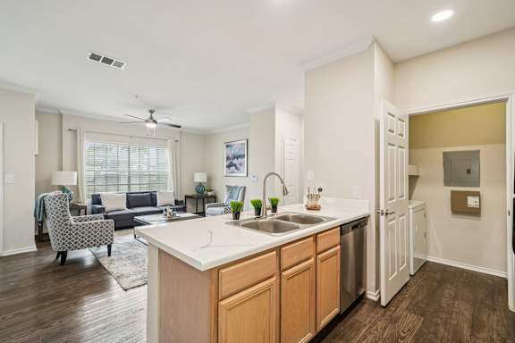 A kitchen with a sink, a refrigerator, and a dining table.